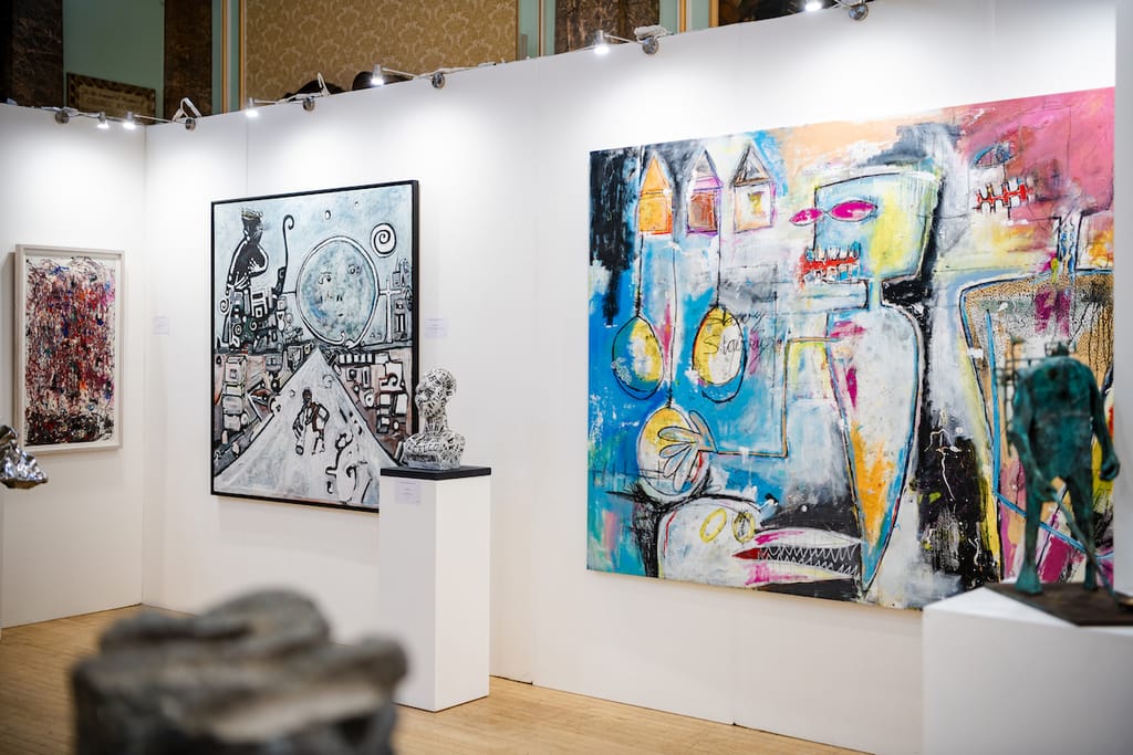 Two large, vividly coloured canvases hung side by side on a white exhibition wall.