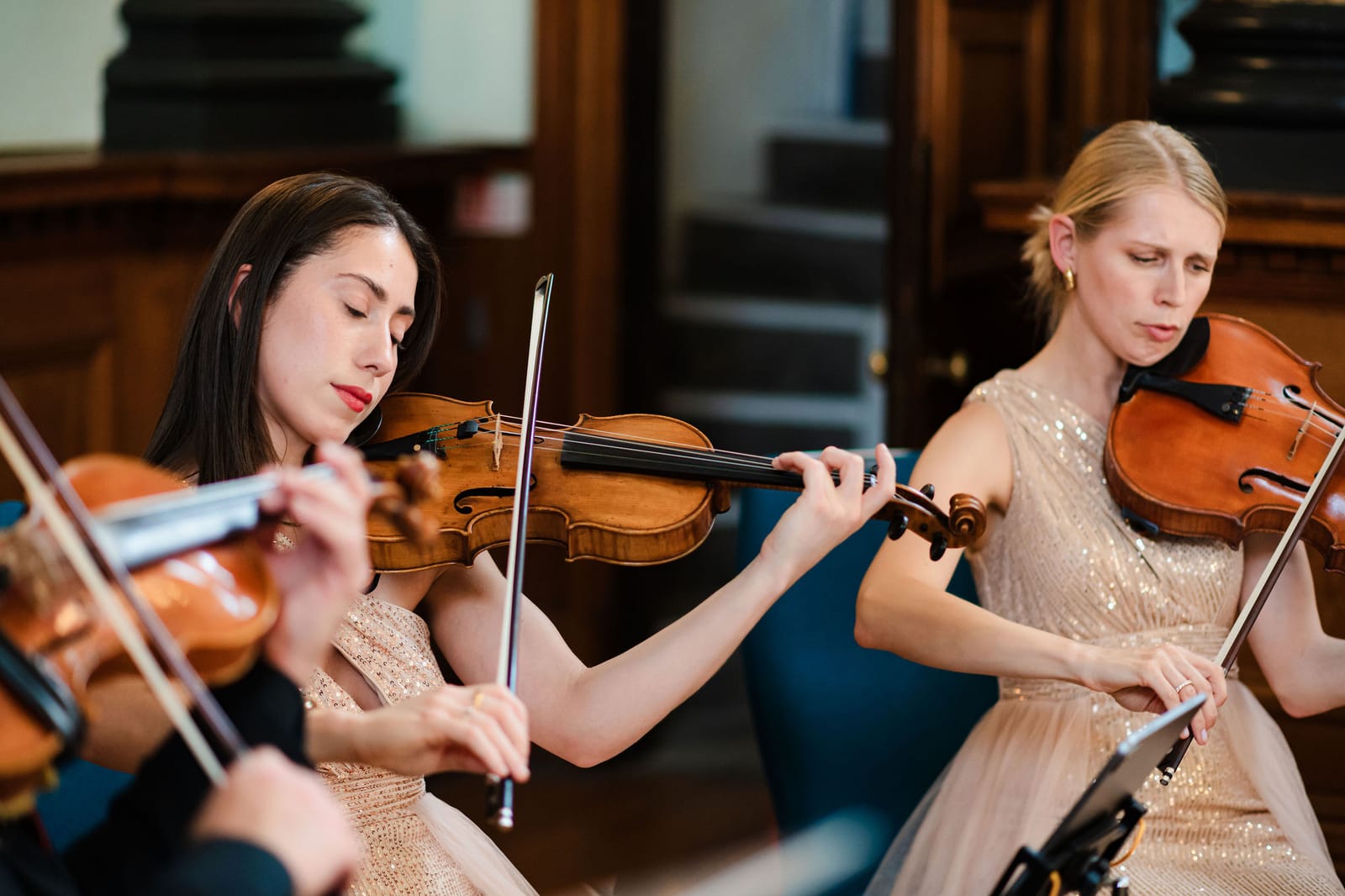 A string quartet performing among the hung works in the main hall.