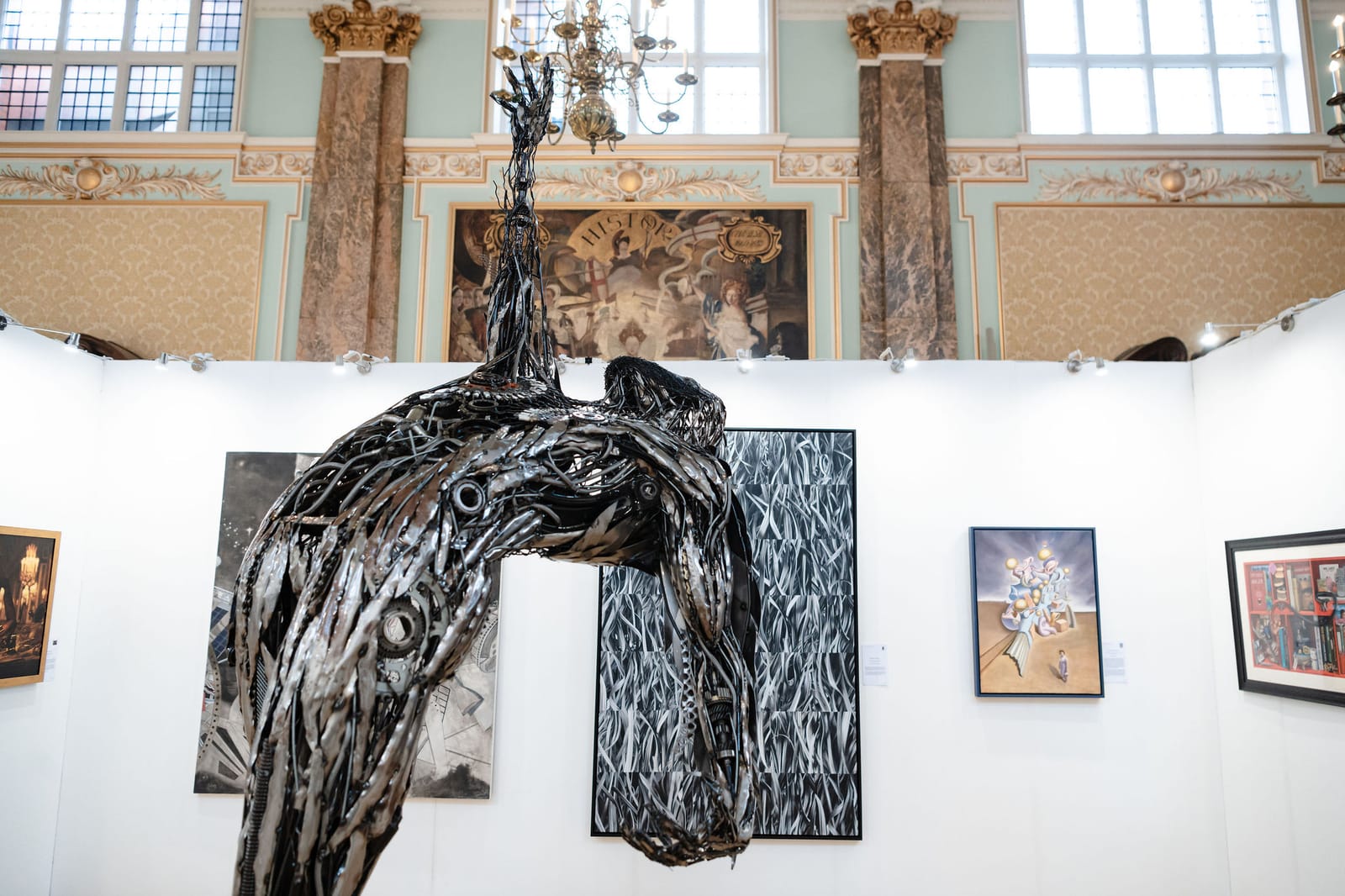 Sculptures on plinths among white exhibition walls in the main hall.