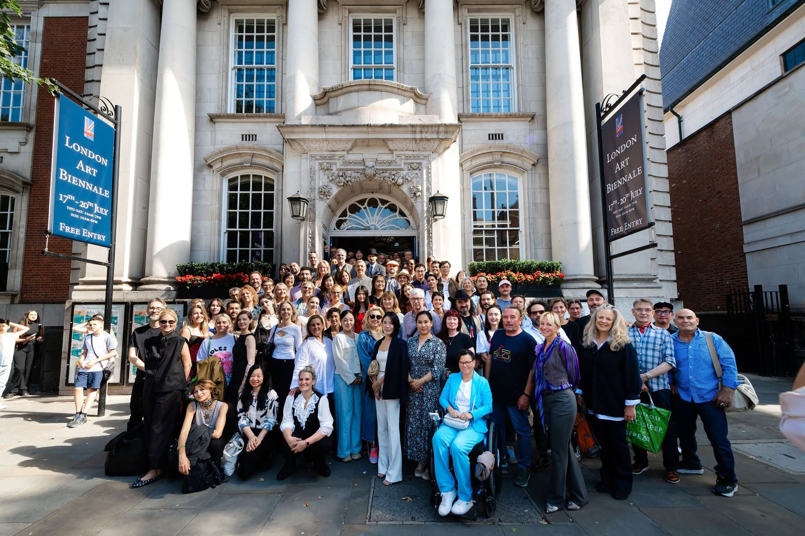 Exhibiting artists gathered on the steps of Chelsea Old Town Hall beneath the Biennale banners.